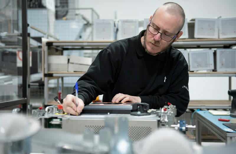 Engineer inspecting automated part