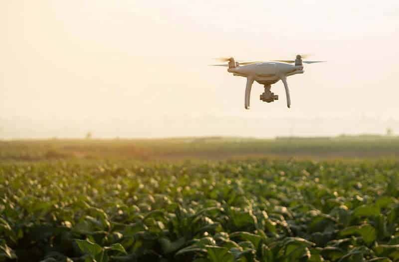 An agritech drone at work over a field