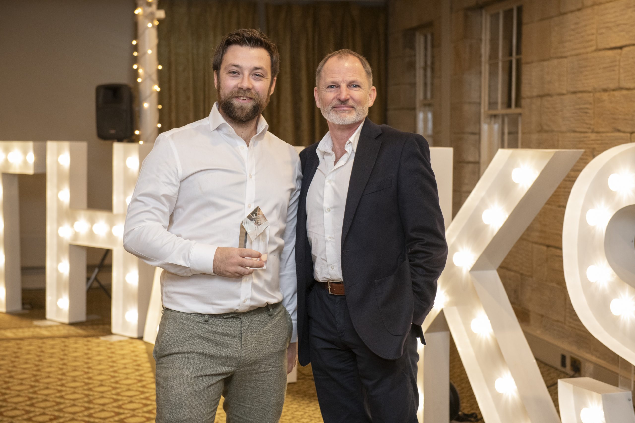 Ed Wilding, Lead Engineer at Tharsus accepting his Chairman's Award from Tharsus Founder, Brian Palmer