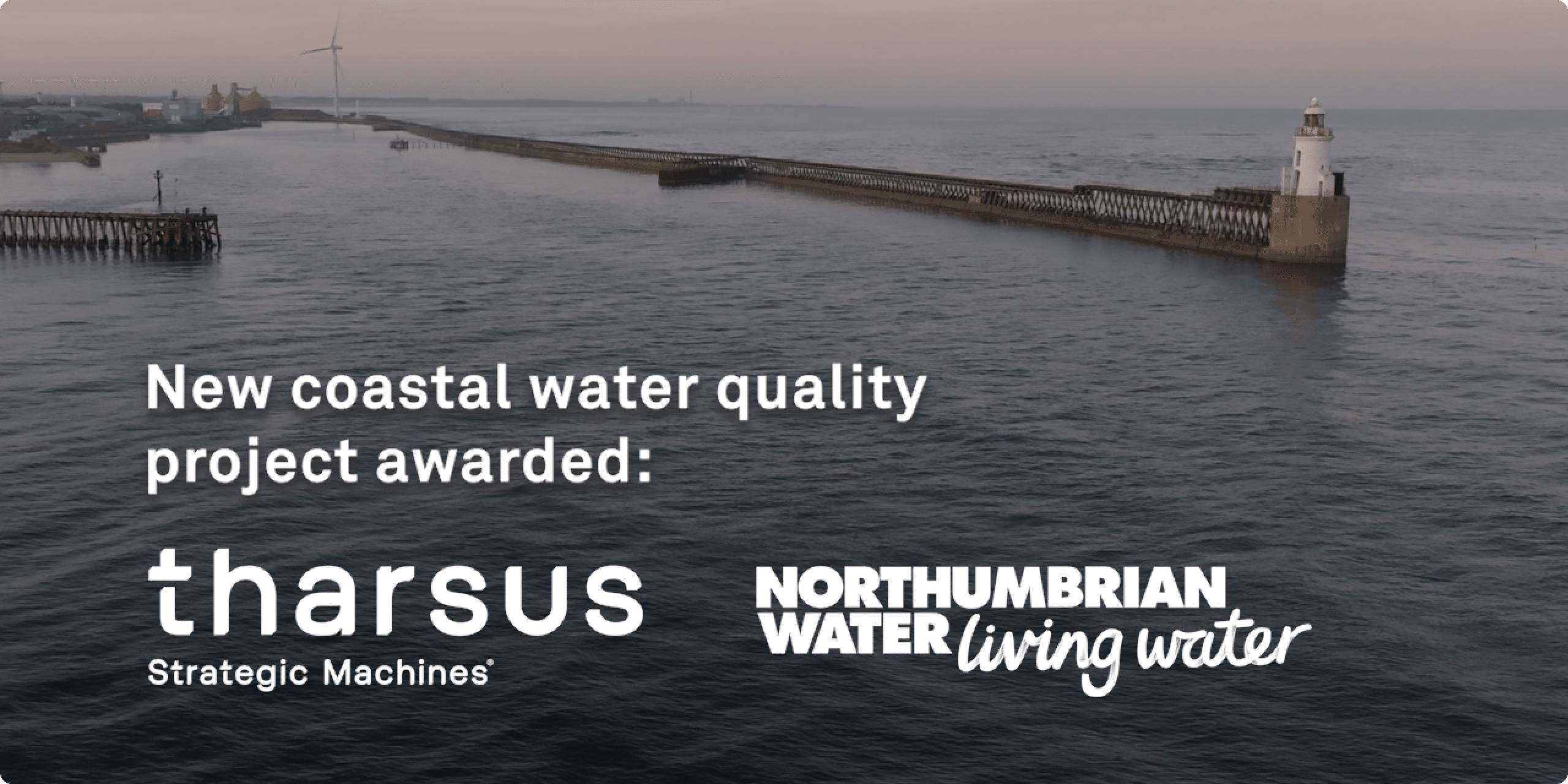 Drone image of a Blyth pier extending into calm grey waters at dusk, with white text overlay announcing Tharsus' partnership with Northumbrian Water