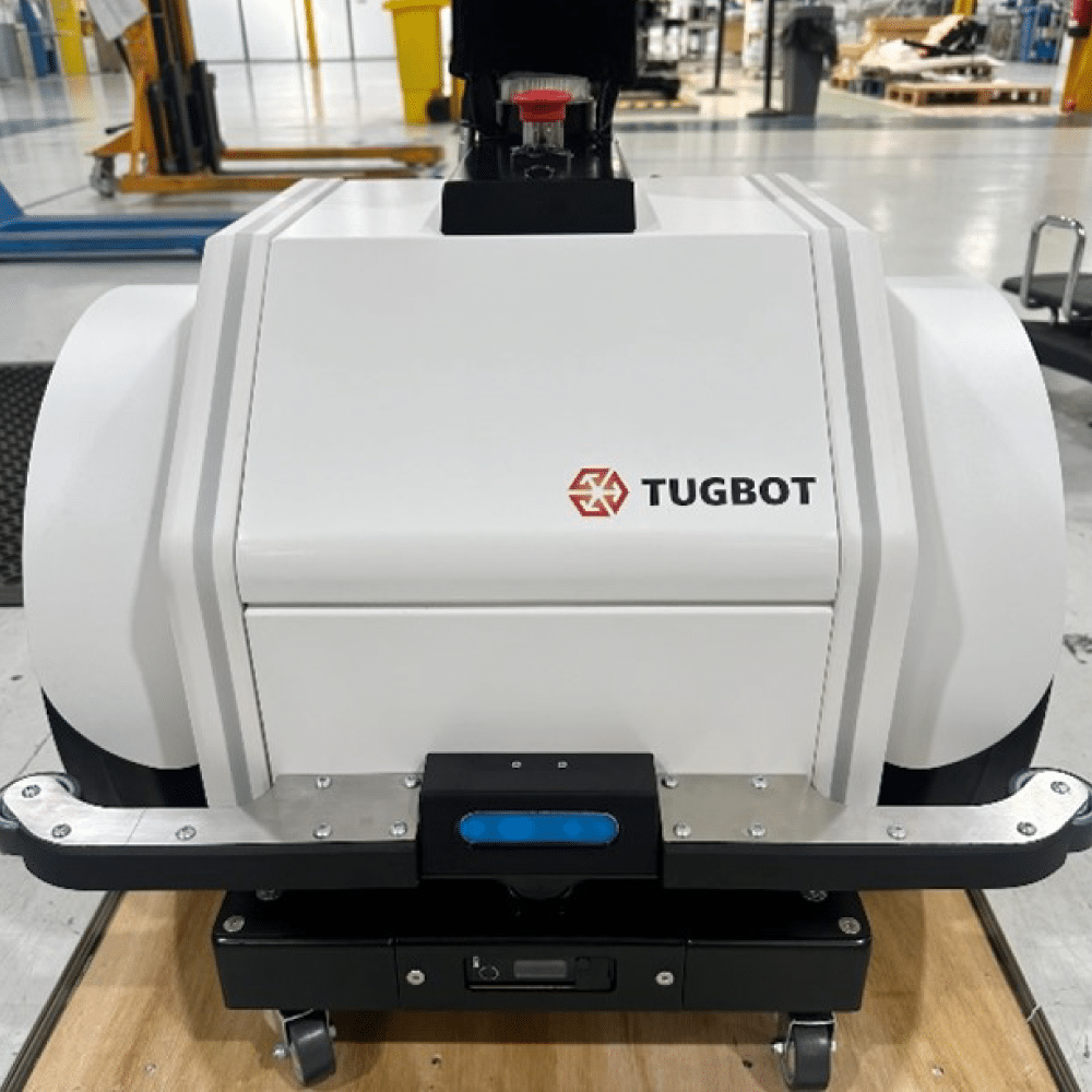 Front view of Tugbot 2 autonomous mobile robot on Tharsus’s assembly line, highlighting its sensor array and Tugbot logo.